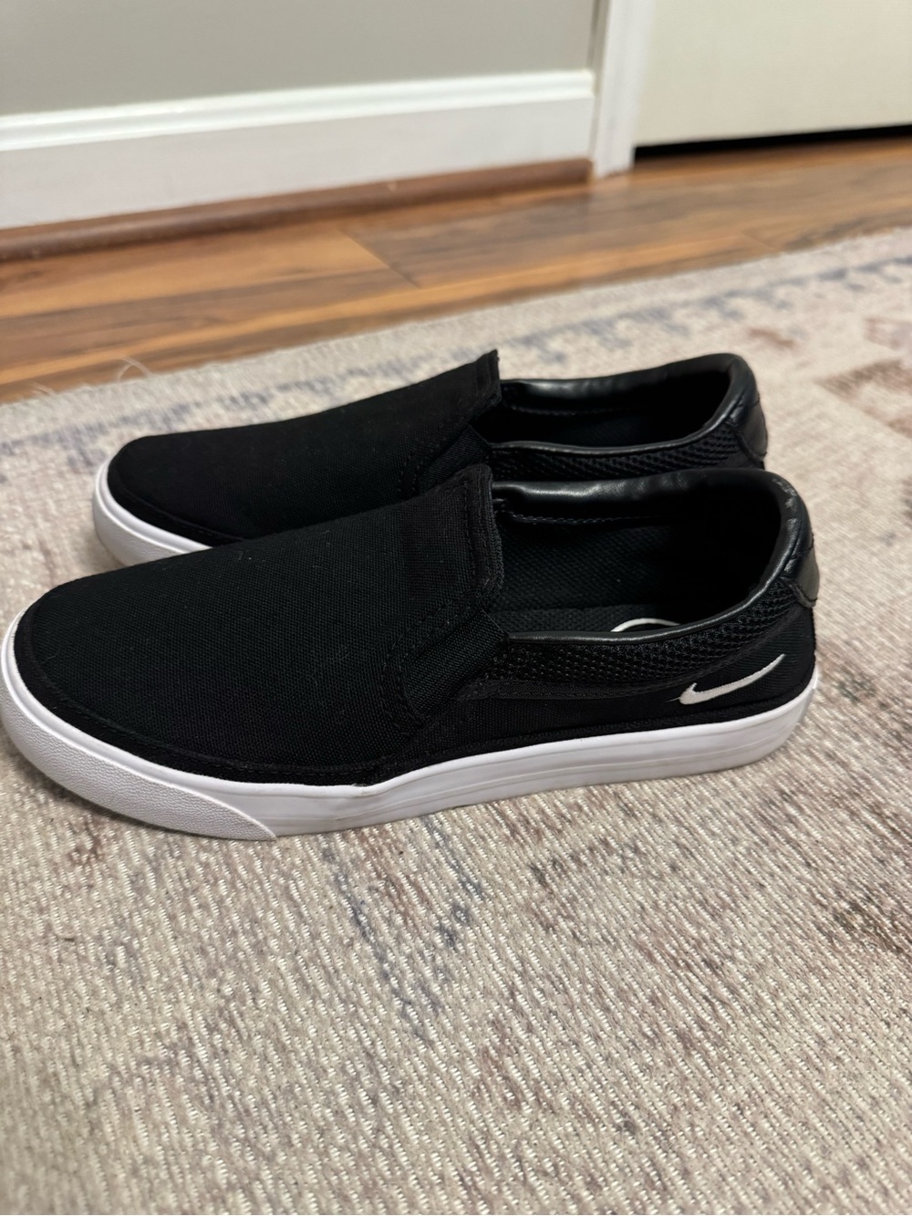 Nike Women’s Black and White Slip-On Court Legacy Sneaker